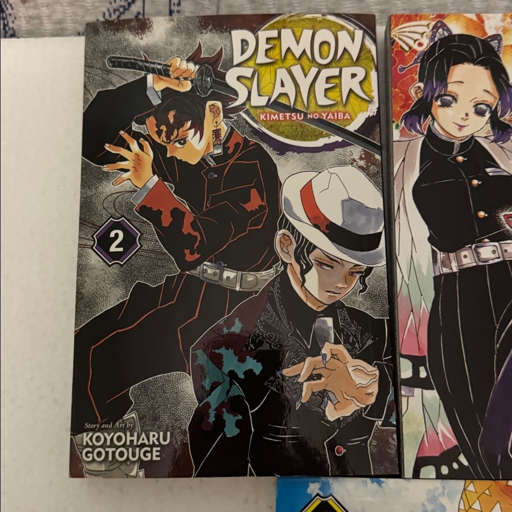 Manga Demon Slayer Volumes — Blue, Yellow, Black, Pink, Orange - Picture 2 of 5